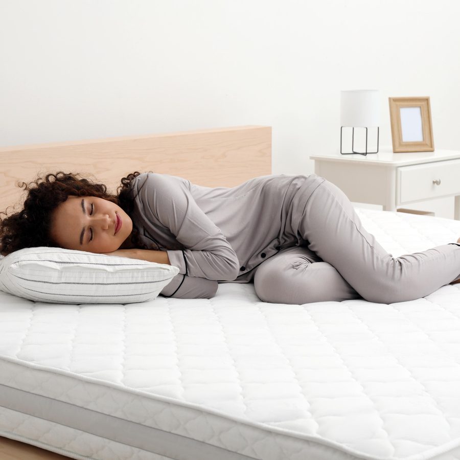 A woman asleep on a mattress